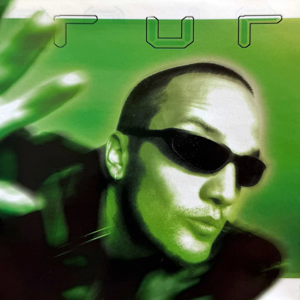 Poppaloopa booklet panel: green-tinted close-up of Kef in dark sunglasses reaching toward the camera