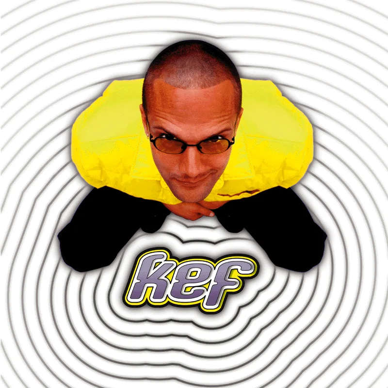 Kef in glasses and a yellow jacket crouching, photographed from above, with the kef logo over swirling rings