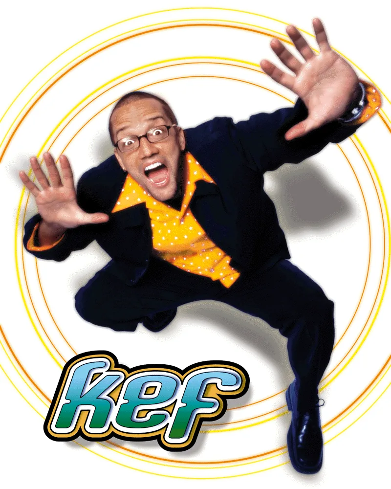 Color promo photo of Kef in a yellow shirt, arms out, inside orange rings
